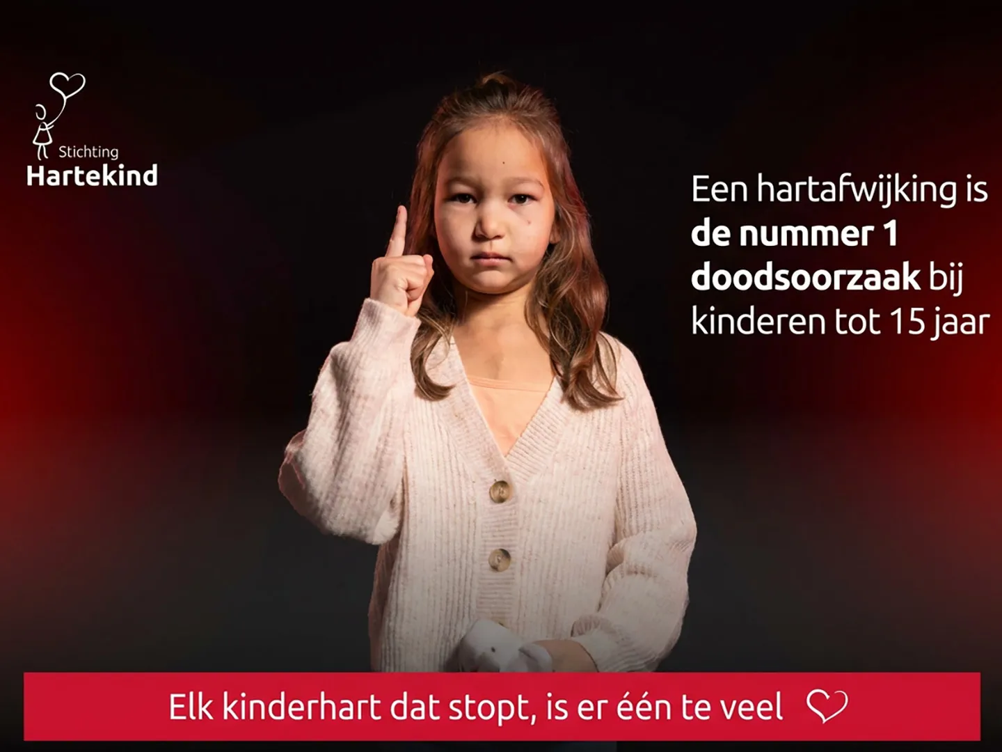 A girl holding up her index finger next to the Dutch words for A heart defect is the number 1 cause of death in children up to 15, with the Stichting Hartekind logo.